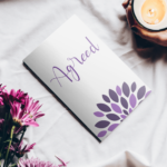 Patty Newbold's book Agreed, hands holding a candle in a mug, and some dark pink flowers